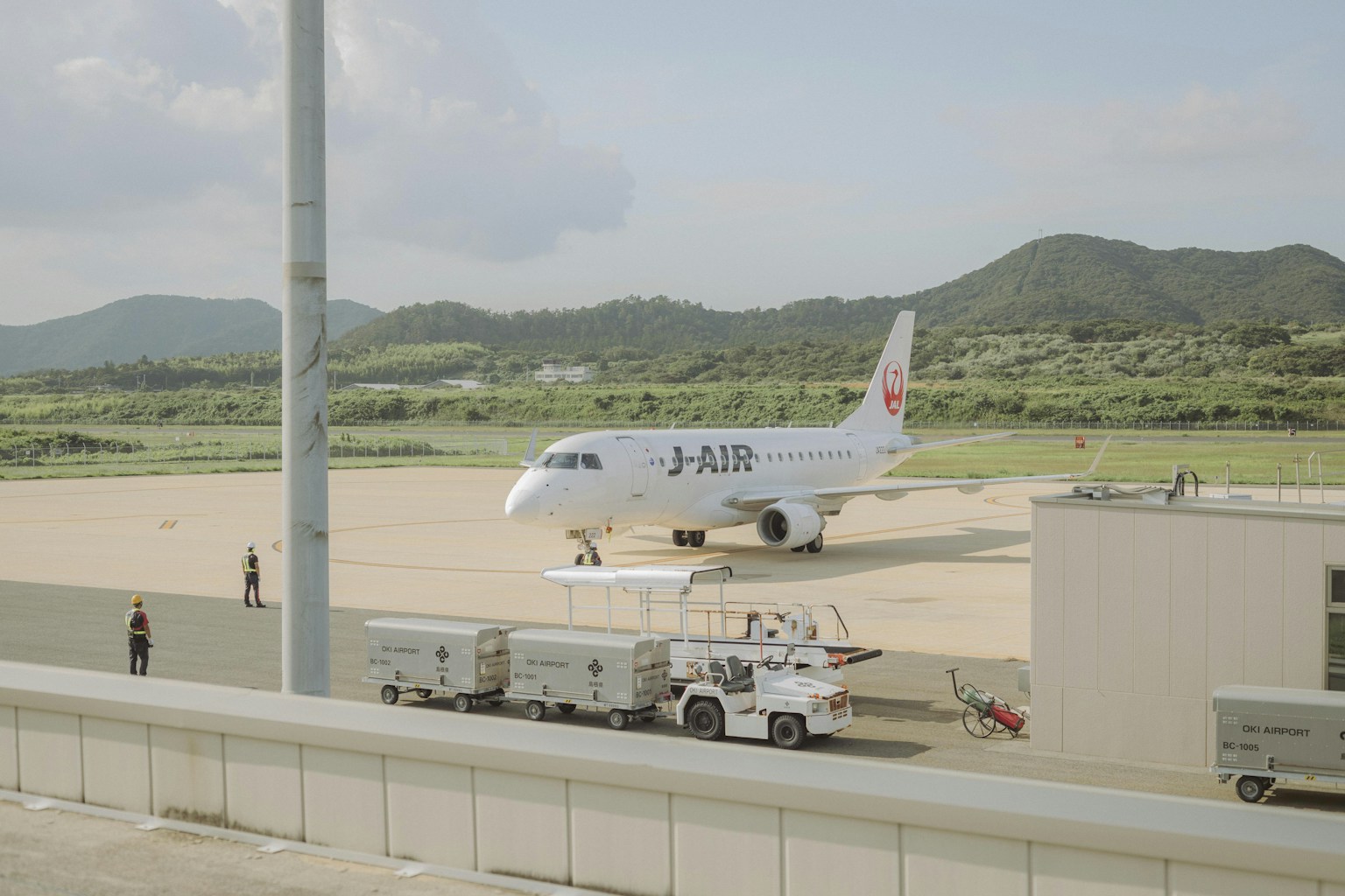 J-air airplane parked on airport tarmac (Photo by Ikuto Nagayama on Unsplash)