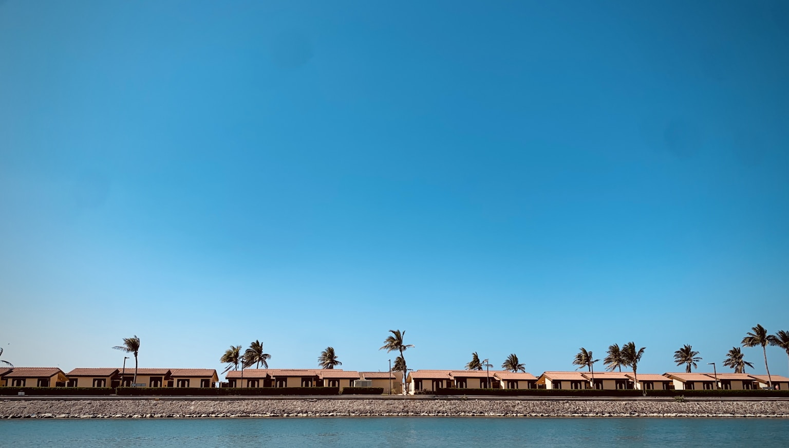 people walking on the beach during daytime (Photo by Richard Glendenning on Unsplash)