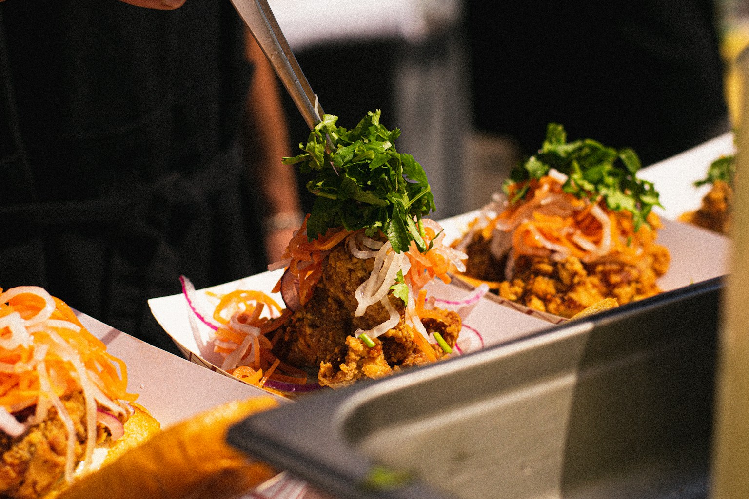 a person cutting food on a plate with a knife (Photo by Mihir Sabnis on Unsplash)