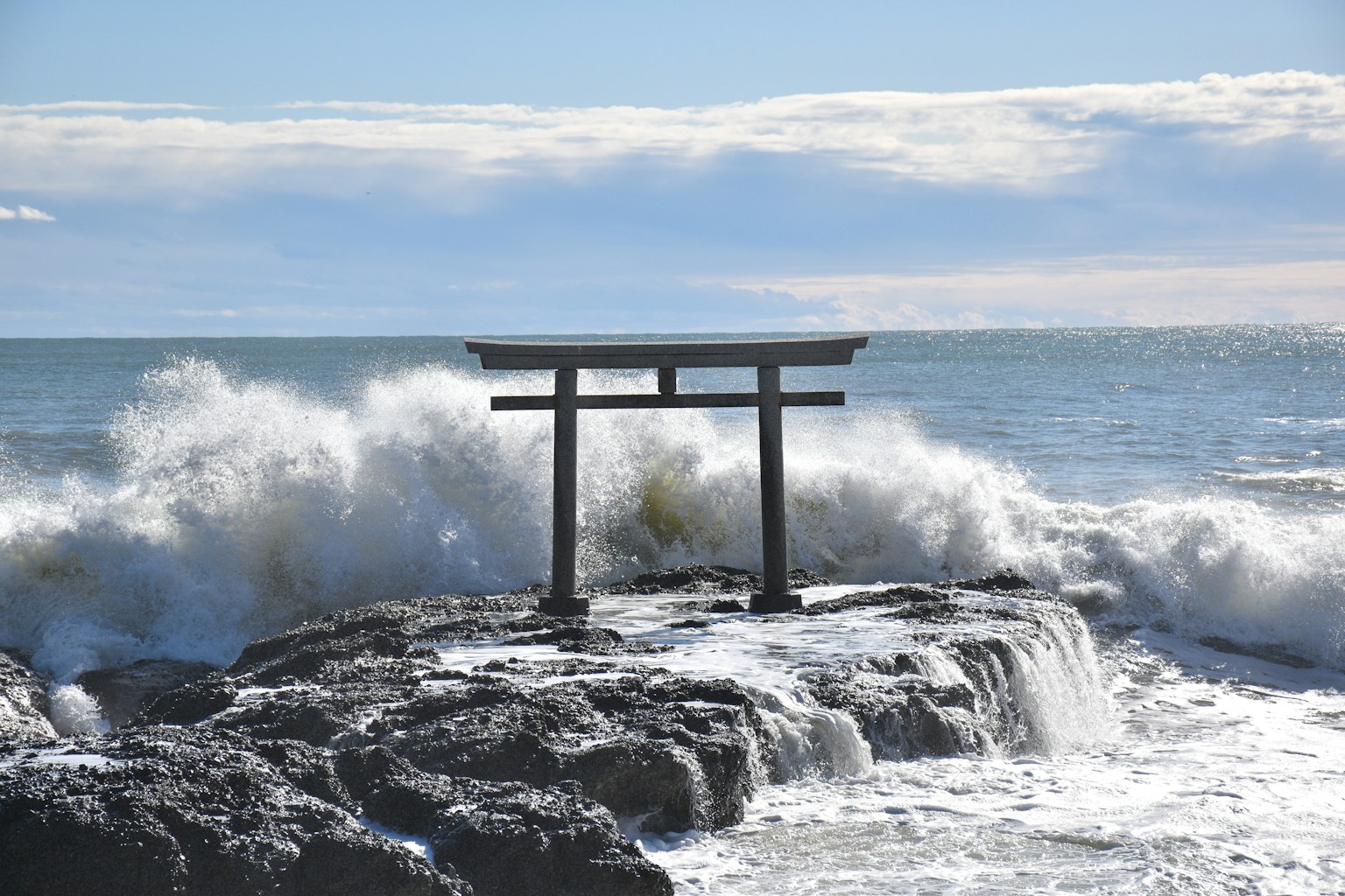 a wooden bench sitting on top of a rock next to the ocean (Photo by Hong Ki Tang on Unsplash)