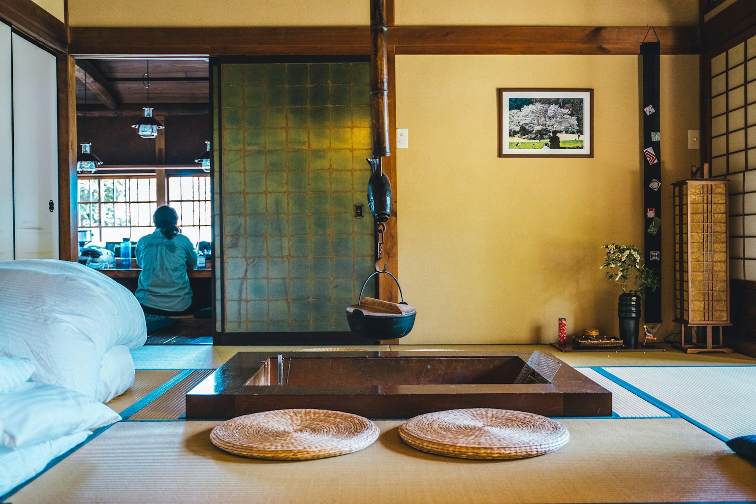 a person sitting on a bed in a room (Photo by Roméo A. on Unsplash)
