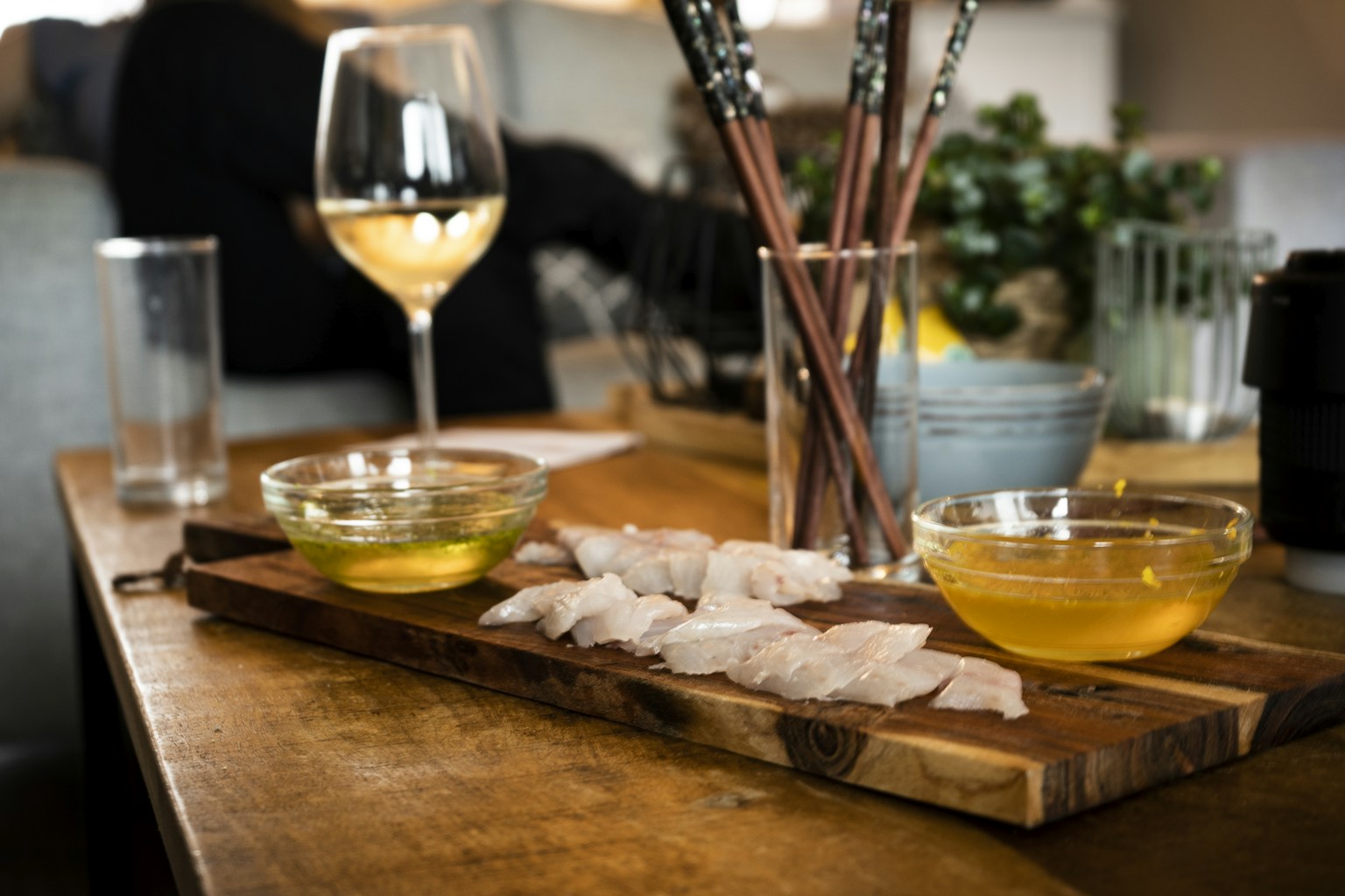 clear wine glass with yellow liquid on brown wooden table (Photo by Paul Einerhand on Unsplash)