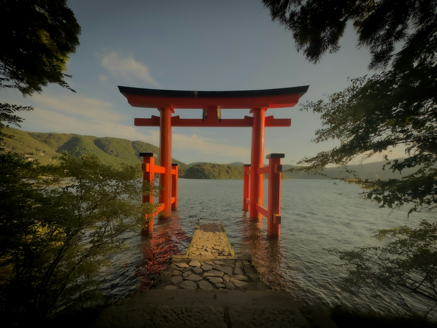 a red tori tori floating on top of a body of water (Photo by Richard Hadiwijaya on Unsplash)
