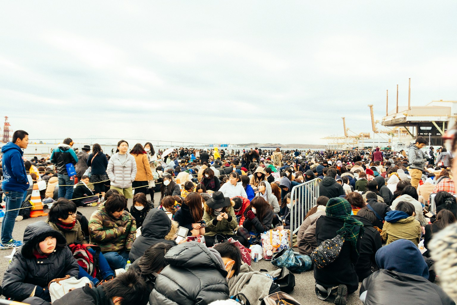 a large group of people sitting on the ground (Photo by Jackie Alexander on Unsplash)
