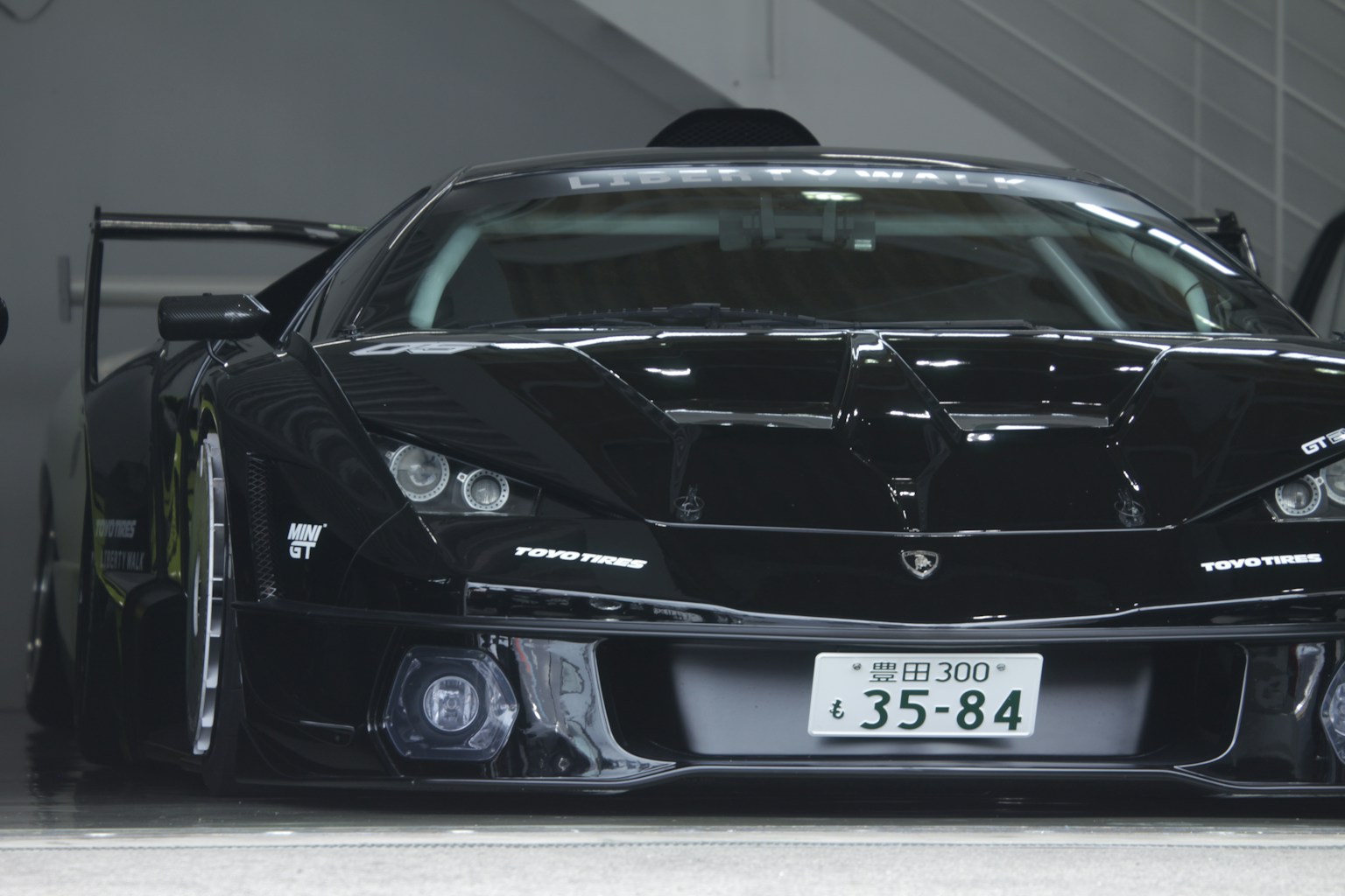 A black sports car with a spoiler. (Photo by Alban on Unsplash)