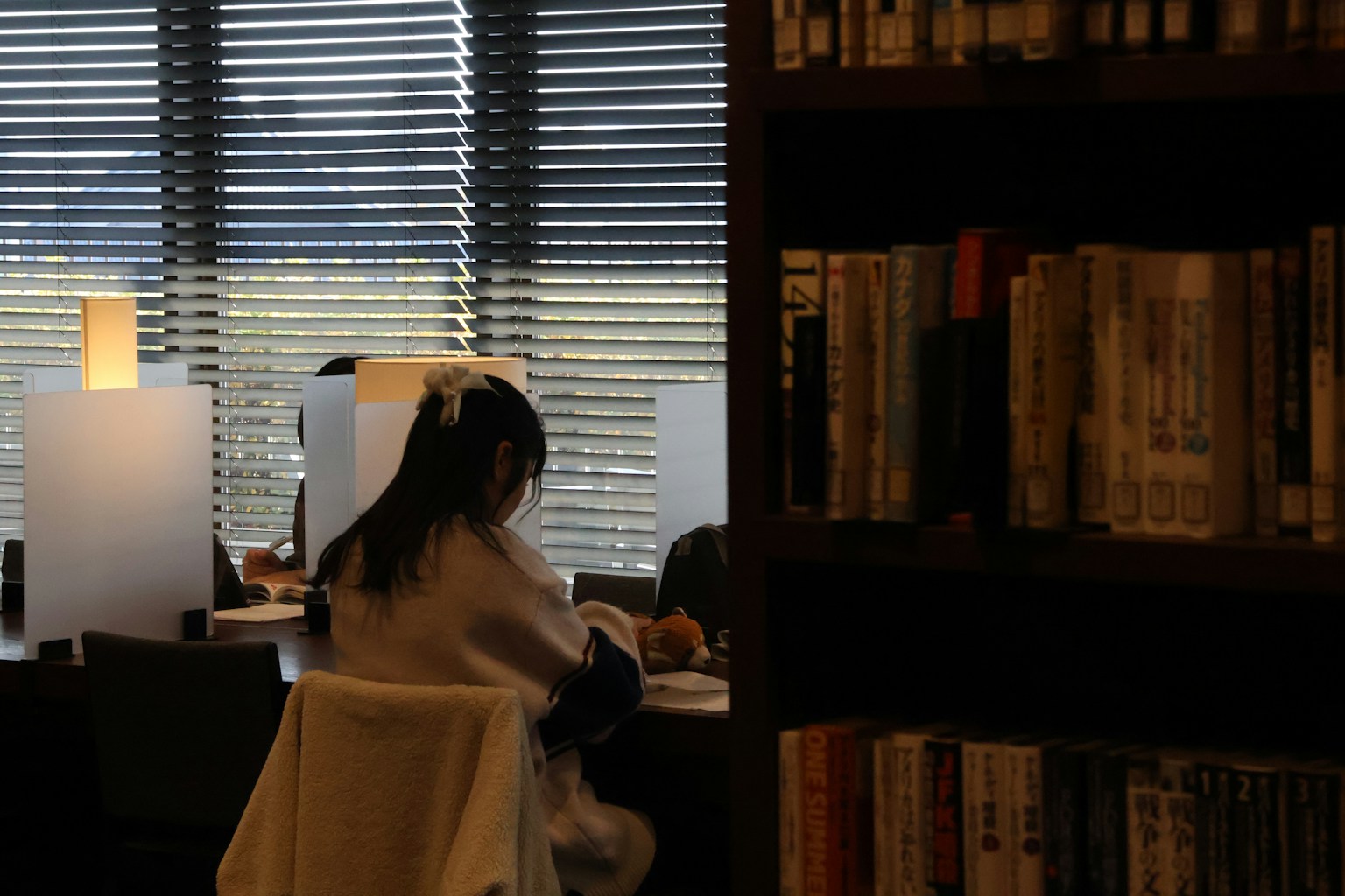 A woman sitting in a chair in front of a window (Photo by Yanhao Fang on Unsplash)