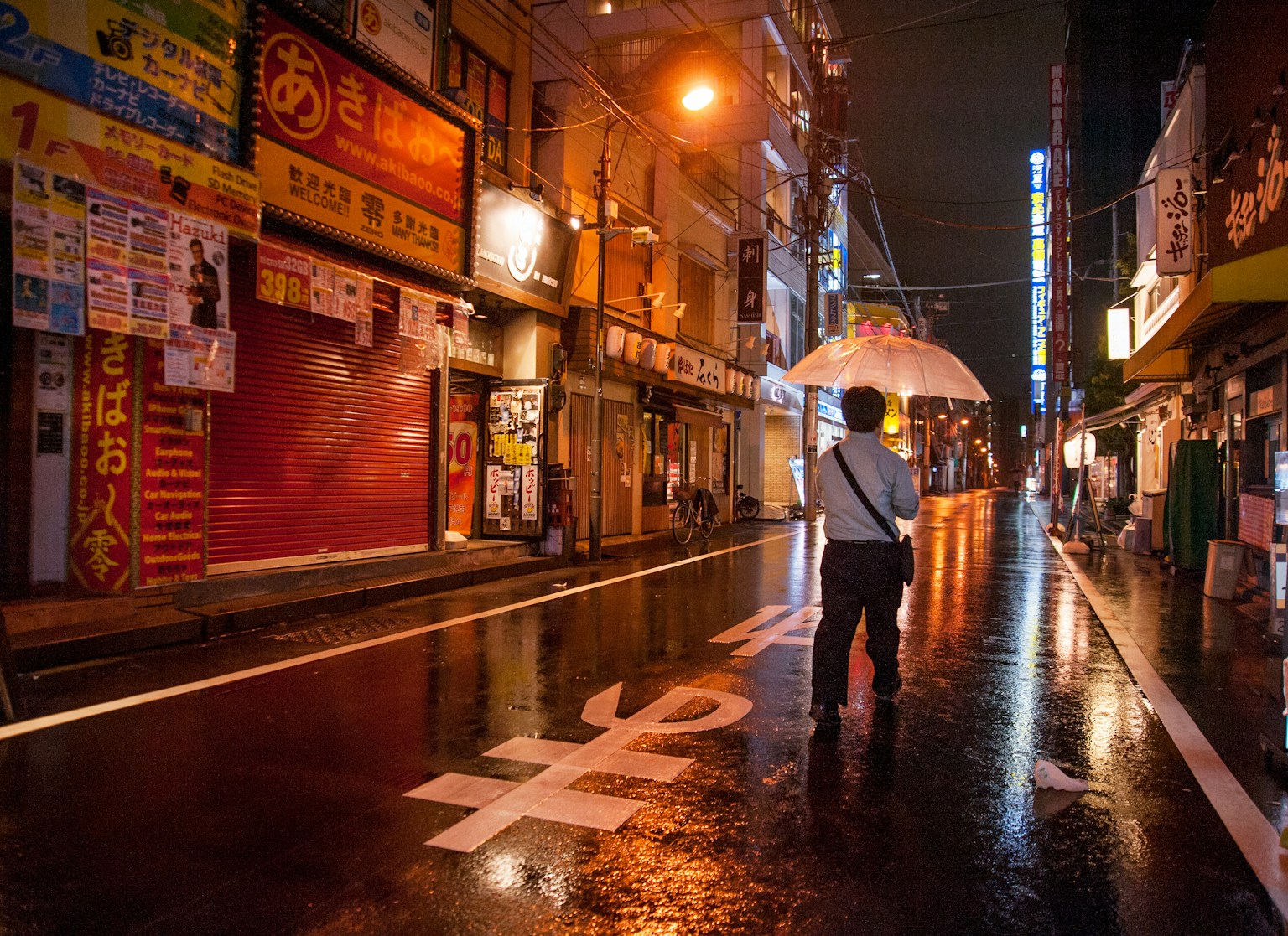 a person walking down a street holding an umbrella (Photo by Evgeny Matveev on Unsplash)