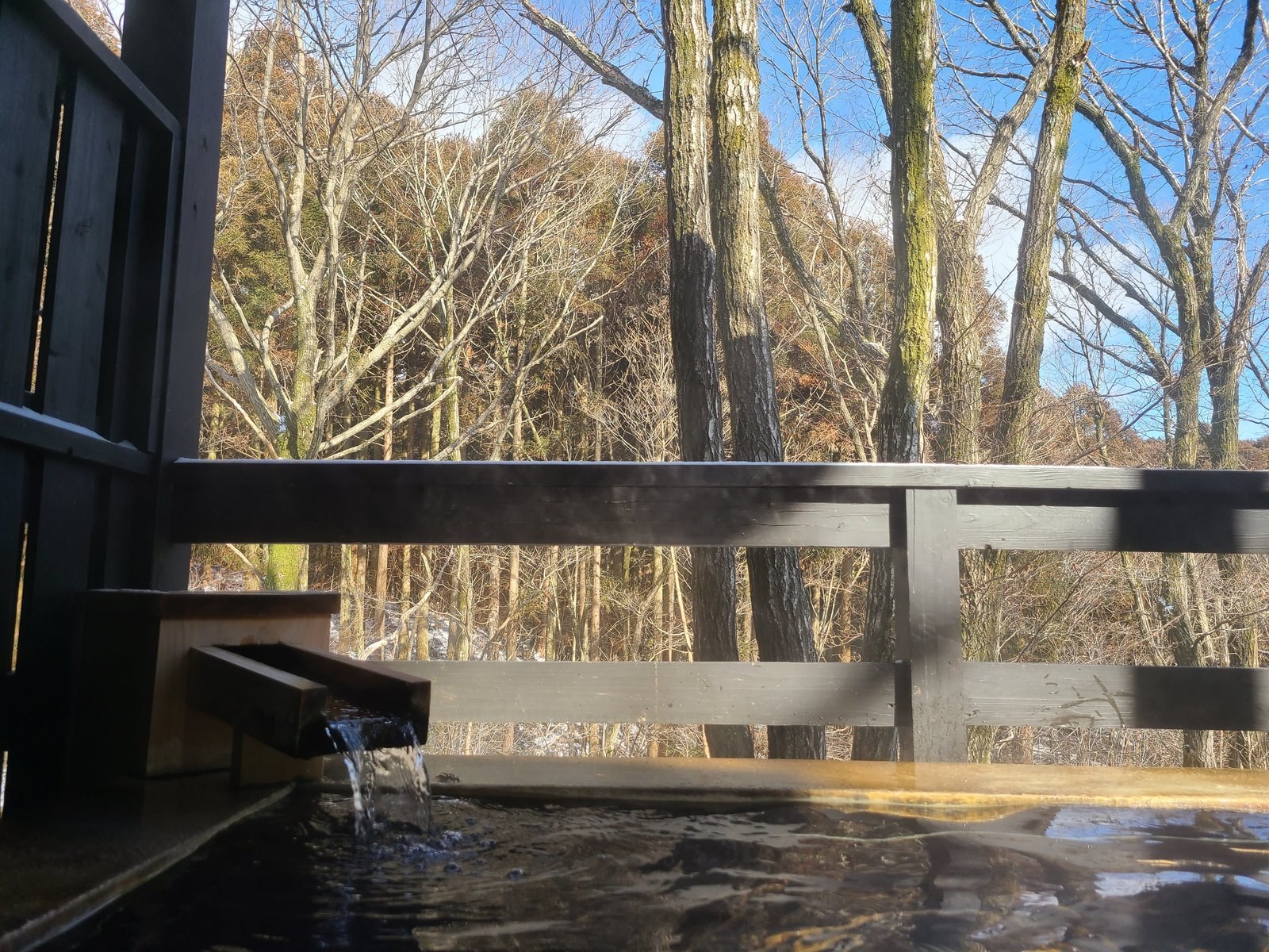 Private kashikiri open-air onsen bath at a ryokan near Aso, Kumamoto