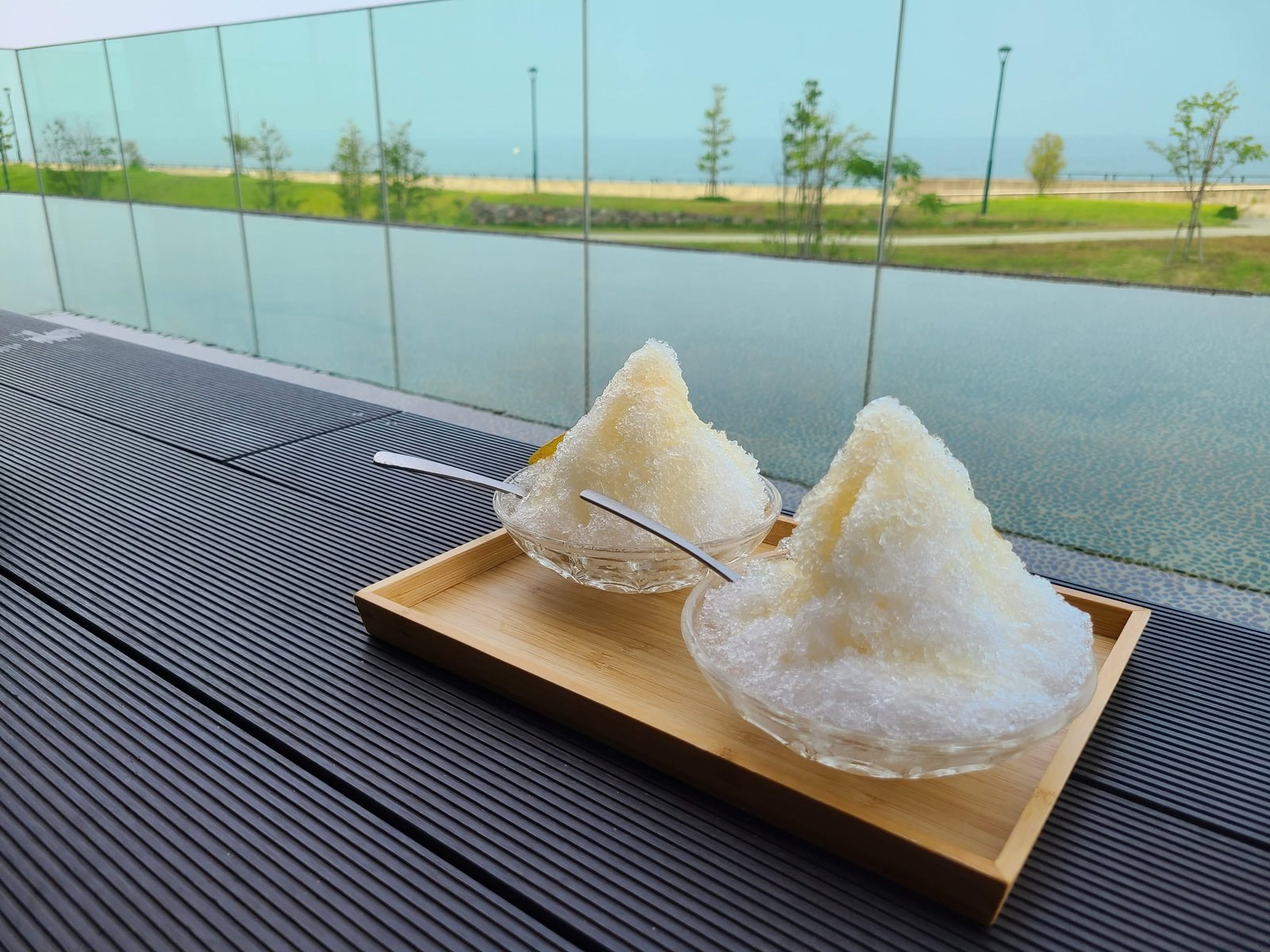 Two bowls of shaved ice beside the footbath at KAI Beppu